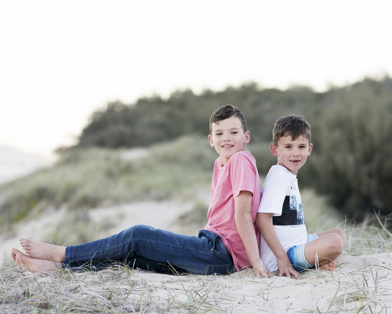 Noosa photographer photographing two brothers sitting on the beach